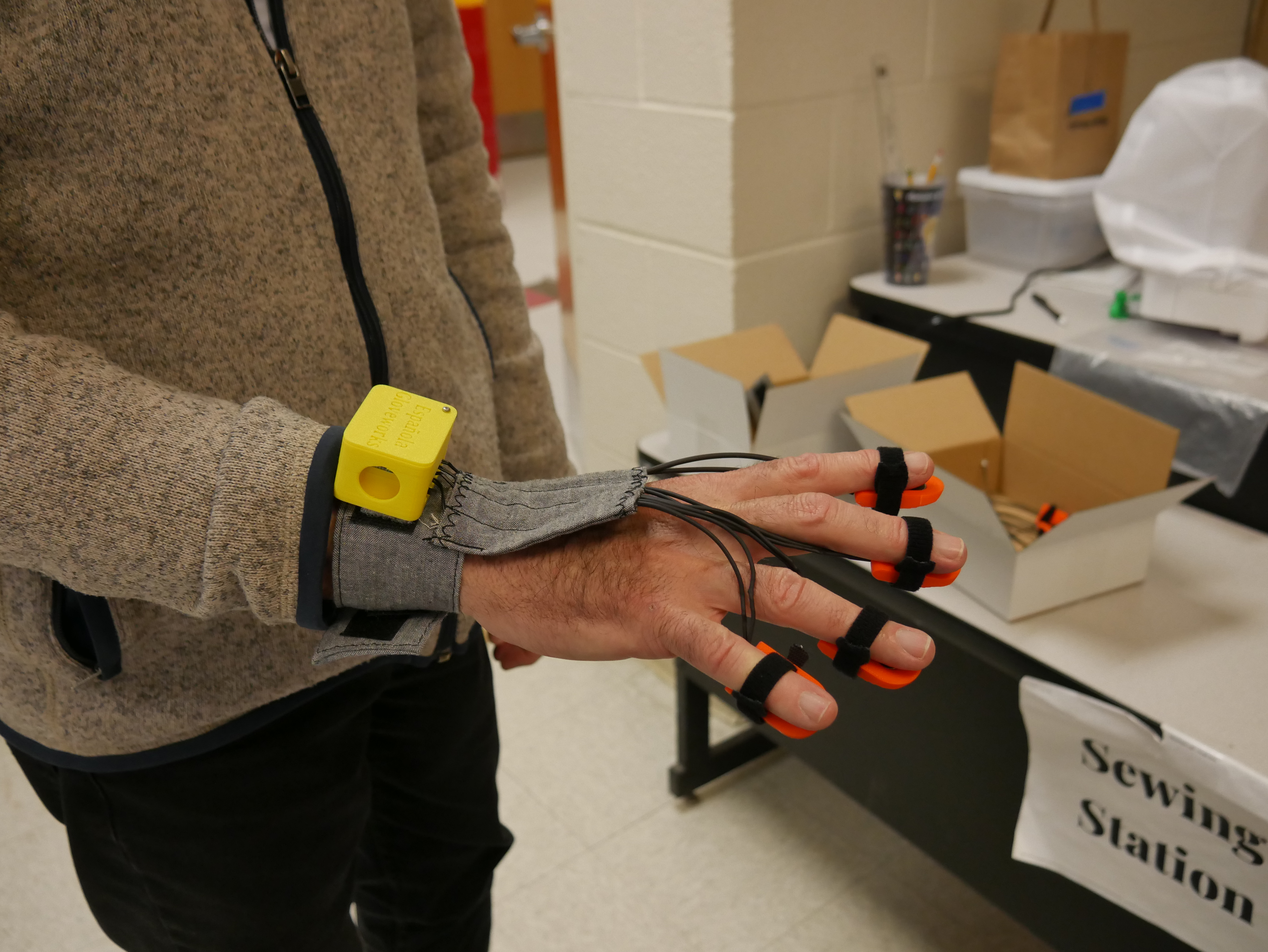A closeup of a hand wearing the Parkinson's glove. 